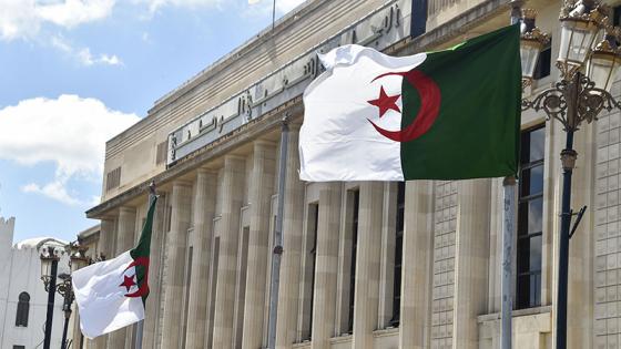 Algerian flags flutter in front of the People's National Assembly (parliament) building in the capital Algiers, on September 10, 2020. (Photo by RYAD KRAMDI / AFP)