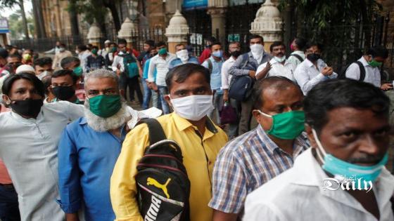 أناس يضعون كمامات للوقاية من فيروس كورونا وينتظرون ركوب حافلة في مومباي في الهندي يوم الأربعاء. تصوير: فرانسيس ماسكارينهاس - رويترز.